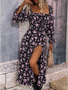 Floral long sleeve dress with side slit and puff sleeves shown in a field setting