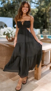 Detail of black tiered sleeveless maxi dress with waist cut-outs and drawstring bust