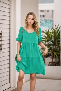 Detail of V-neckline and ruffled short sleeves on a turquoise green tiered summer dress