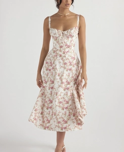 Close-up of floral sundress featuring delicate rose print and bow tie detailing on chest