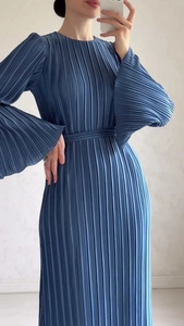 Detail view of blue pleated midi dress featuring elegant flared sleeves and waist belt