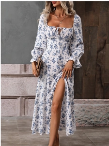 Detail of bohemian long sleeve dress with blue floral print and high side slit
