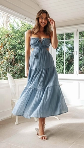 Detail of blue tiered maxi dress featuring cutout waist and tassel drawstring neck