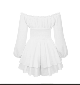 Detail of white Swiss dot fabric with elastic smocked waist and ruffled hem romper