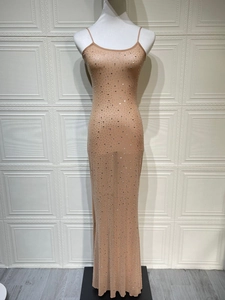 Detailed close-up of glittering silver rhinestones on a sheer nude fishtail evening gown