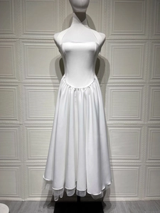 Detail of white halter neck satin gown showing mesh tutu layers and u-shaped waistline
