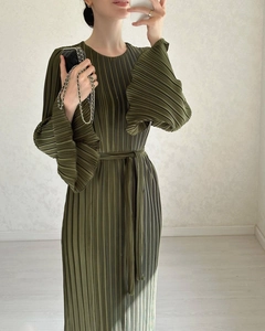 Detail of olive green pleated maxi dress with flared ruffled cuffs and waist tie