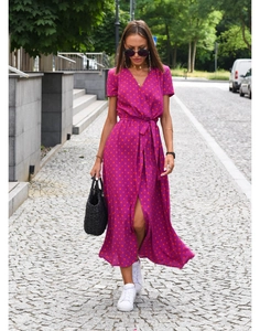 Detail of V-neck wrap dress in plum with orange polka dots and waist tie closure