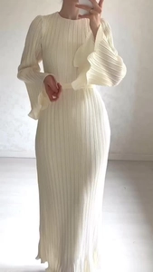 Detail of cream pleated maxi dress featuring elegant flared sleeves and round neckline