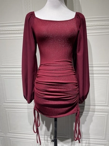 Detail view of the burgundy glitter fabric with adjustable side drawstrings and ruching