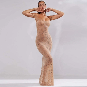 Close-up of sparkling champagne gold sequins on an elegant mermaid evening gown