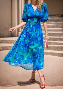 Detail of V-neck floral midi dress with puff sleeves and elastic waist in blue