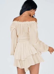 Detail of ruffled back design and tiered layers on cream chiffon off-shoulder romper