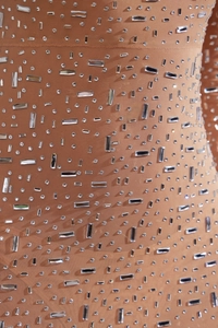 Macro view of high-density rhinestones and crystals on skin-toned mesh mermaid dress