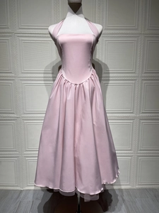 Detail of light pink halter neck dress featuring pleated waist and satin fabric texture