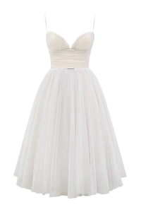 Detailed view of white mesh dress featuring elegant side ruffles and bow accents