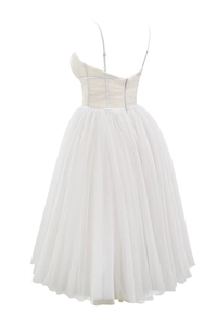 Close-up of white corset bodice and multilayered tulle skirt on the formal dress