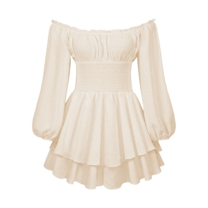 Macro detail of beige Swiss dot fabric with smocking waist and layered ruffle hem