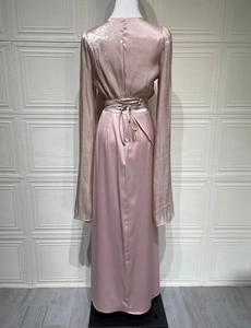 Detail view of pink satin dress back featuring adjustable waist ties and batwing sleeves