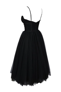 Detail of corset-style pleated bodice and multi-layer black tulle skirt on evening dress