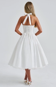 Detailed back view of white halter neck puff dress with large bow and lace-up corset detail