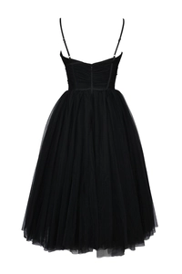 Detailed view of the layered black mesh fabric and corset-style bodice on the dress