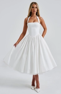 Detail of the white halter neck midi dress featuring a pleated flared skirt and satin finish