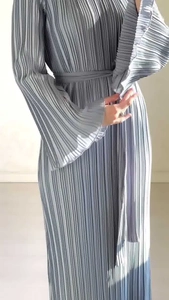 Detail view of light blue pleated maxi dress featuring elegant flared sleeves and waist tie