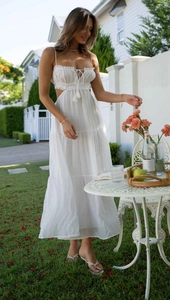 Detail of white tiered maxi dress with waist cut-outs and delicate tassel drawstring