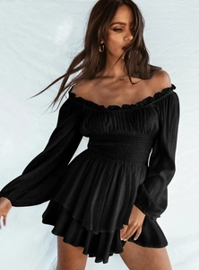 Close-up of black off-shoulder playsuit with ruffled neckline and swiss dot texture