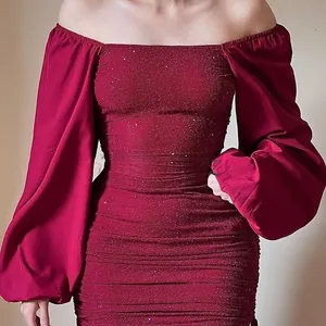 Detailed ruching and glitter fabric texture on a burgundy off-shoulder party dress
