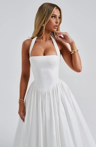 Detail of the white halter-neck corset bodice and elegant flowing puffy skirt