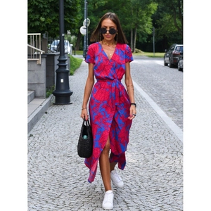 Floral print wrap dress in royal blue with V-neck and waist tie on a city street