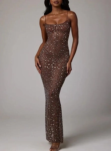 Detailed close-up of sparkling silver sequins on the dark brown mermaid evening gown fabric