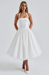 Detail of white halter midi dress with corset bodice and voluminous pleated tulle skirt