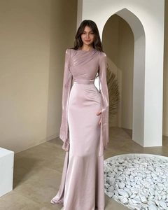 Detail of satin dress featuring cross-pleated waist and elegant slit sleeves with fringe
