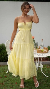 Detail of light yellow sleeveless tiered maxi dress with cutout waist and drawstring chest
