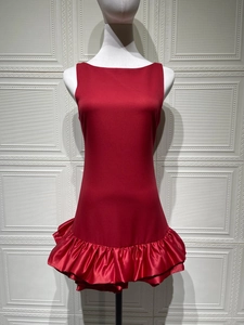 Detail of red sleeveless mini dress featuring layered ruffle hem and smooth satin-like fabric