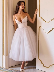 Elegant light pink mesh tulle midi dress with V-neckline and bow detail for formal parties