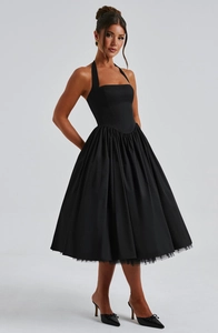 Detail of elegant black halter dress with mesh lining hem and flared silhouette