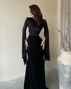 Detail of elegant black slim-fit gown featuring long fringe sleeves and gathered silk bodice