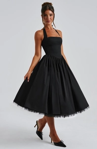 Detail of elegant black ball gown dress showing square neck bodice and layered tulle hem