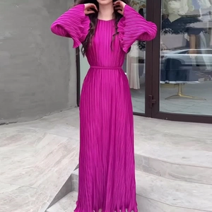 Detail of elegant pleated flare sleeves on a vibrant fuchsia long-sleeve midi dress