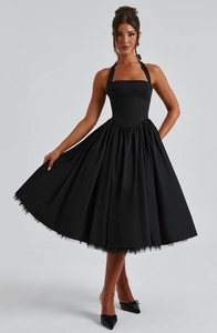 Detail of black halter puff dress with vintage tulle hem and elegant bow heels
