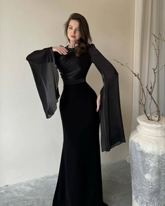 Detail of elegant black evening gown featuring draped silk bodice and wide flared mesh sleeves