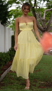 Detailed view of yellow tiered maxi dress with cutout waist and drawstring bust