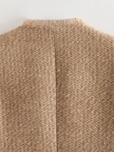 Macro detail of khaki tweed jacket neckline featuring premium frayed fringe texture