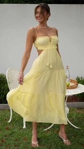 Detail of yellow backless tiered maxi dress with drawstring tassels and side cut-outs