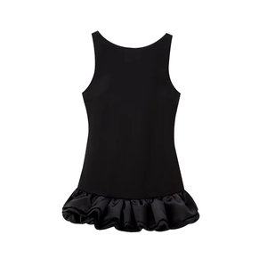 Detail of black sleeveless mini dress featuring ruffled hem and slim-fit halter neck design