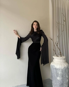 Detailed view of elegant black gown featuring sheer chiffon sleeves and a slim fit bodice